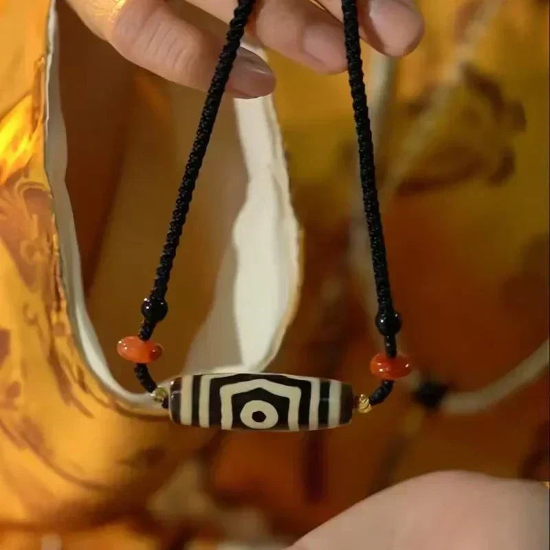 Handwoven cord Dzi bead pendant necklace, traditional Tibetan spiritual jewelry