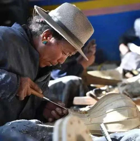 Tibetan senior artisan handcrafting traditional handmade jewelry, ancient handicraft heritage