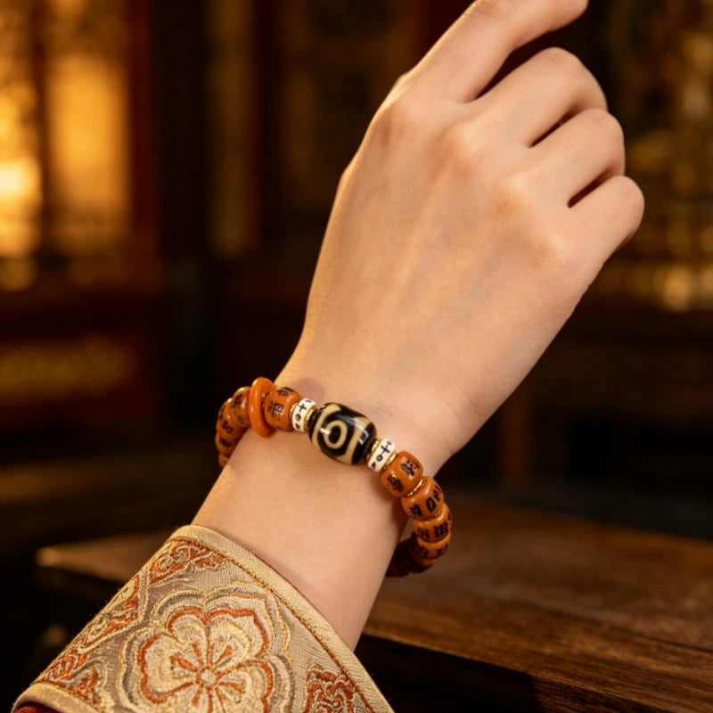 Tibetan six syllable mantra Yak bone bracelet with dzi bead worn on wrist, ethnic handmade spiritual ornament.