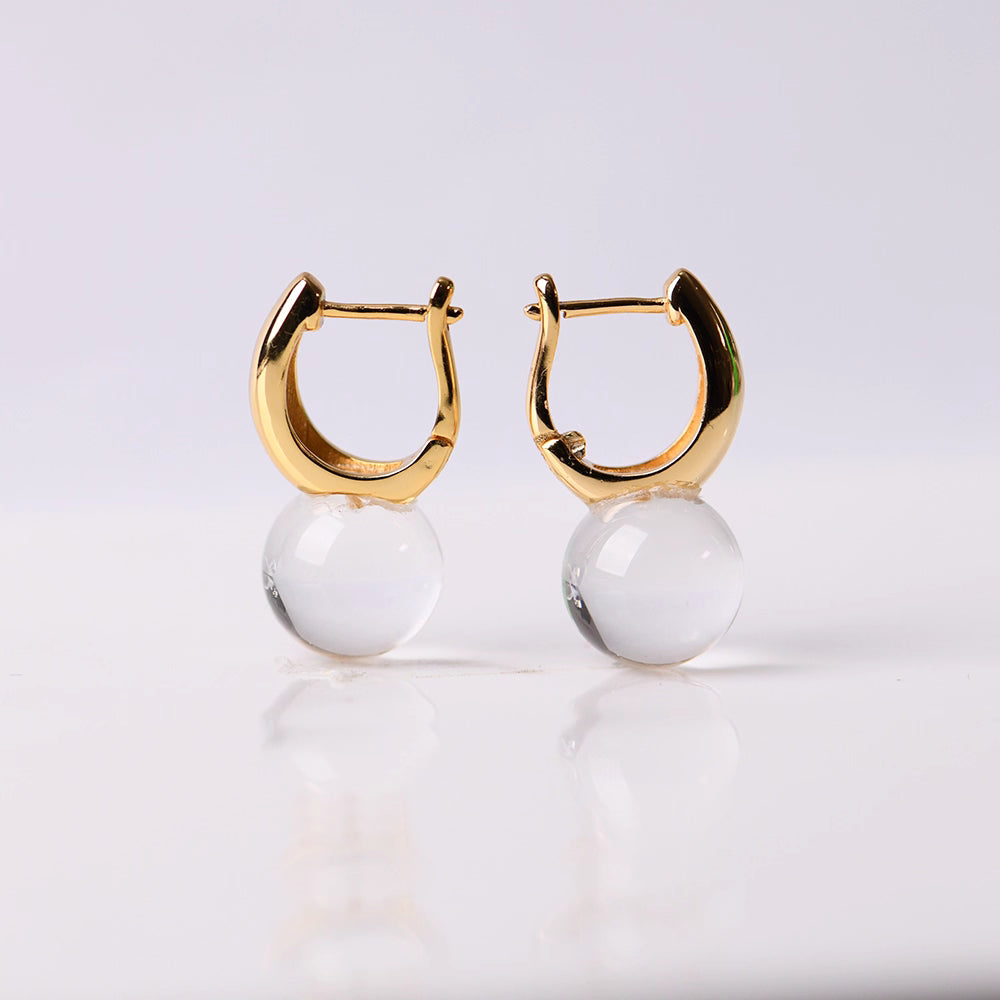 Minimalist design meets spiritual healing with these transparent quartz drop earrings. The silver-gold-plated setting enhances the natural beauty of the crystal, making it a perfect gift for someone special.