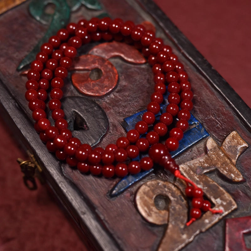 Crafted with red glass beads, it is intended to bring vitality and blessings to the wearer.