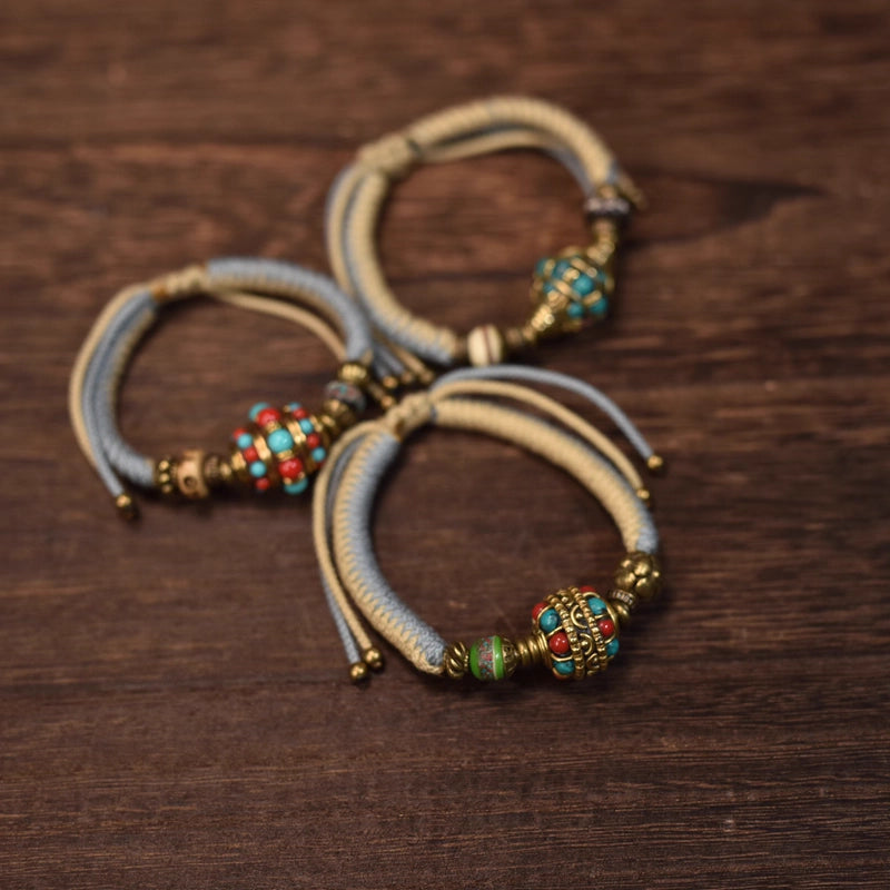 Tibetan craftsmen hand-weave spiritual beaded bracelets