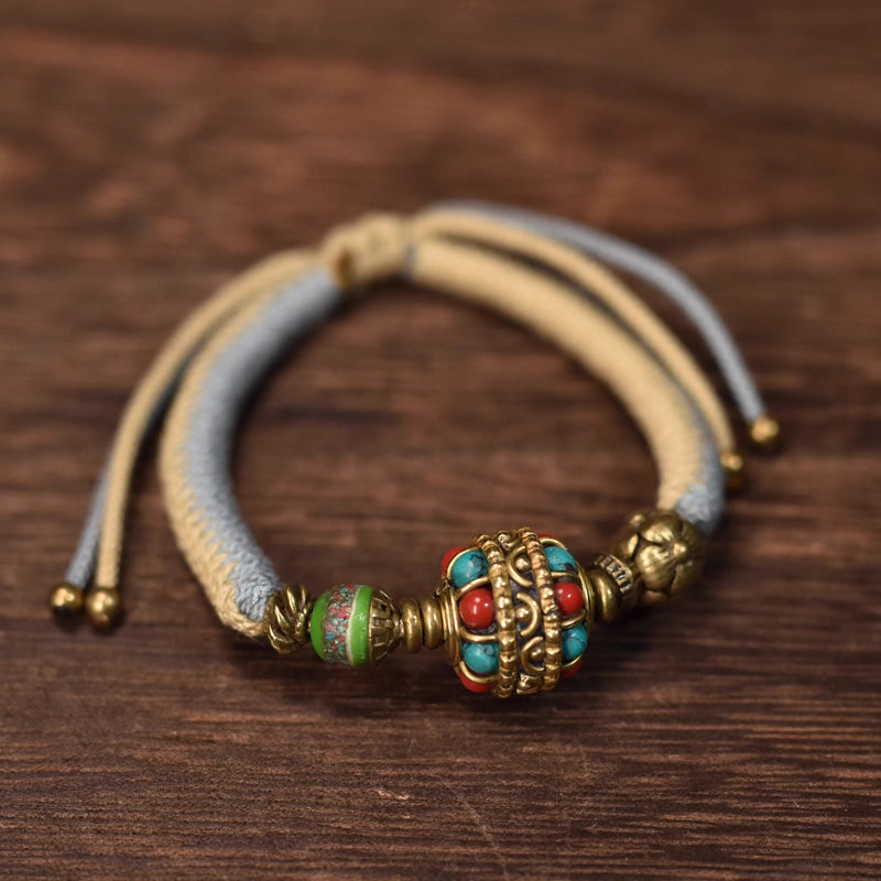 Tibetan craftsmen hand-weave spiritual beaded bracelets