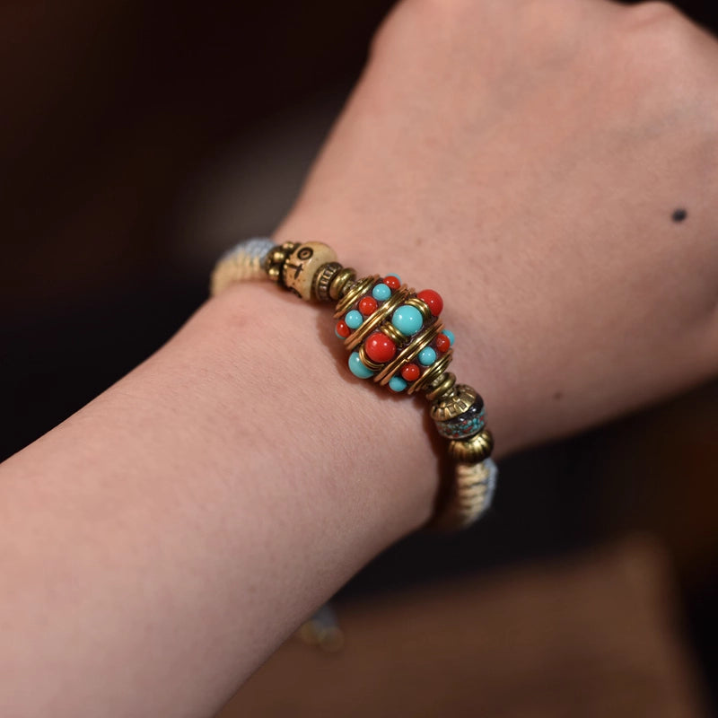 Tibetan craftsmen hand-weave spiritual beaded bracelets