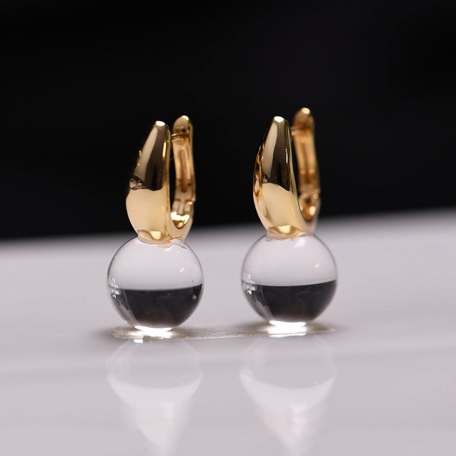 Elegant silver-gold-plated drop earrings featuring natural transparent quartz crystals, perfect for adding a touch of spiritual elegance to any outfit.