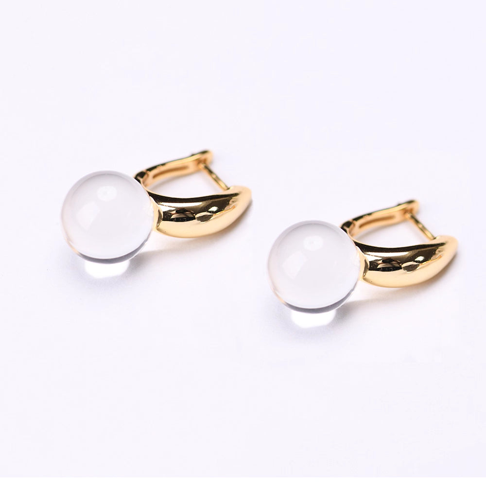 These dainty silver-gold-plated drop earrings feature a single transparent quartz crystal, a powerful stone for energy healing and chakra balance. Ideal for everyday wear or as a thoughtful spiritual gift.