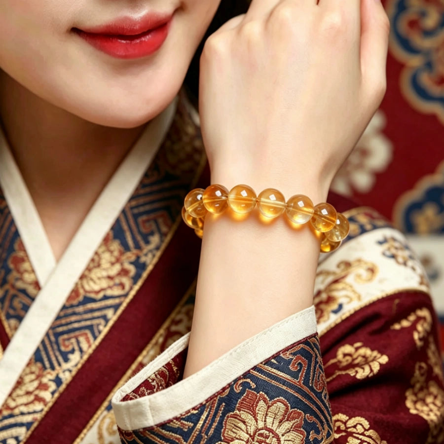 Natural golden citrine quartz bracelet worn on wrist, model with traditional Tibetan embroidered outfit, prosperity crystal jewelry