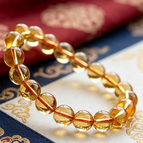 Natural golden citrine quartz bracelet worn on wrist, model with traditional Tibetan embroidered outfit, prosperity crystal jewelry