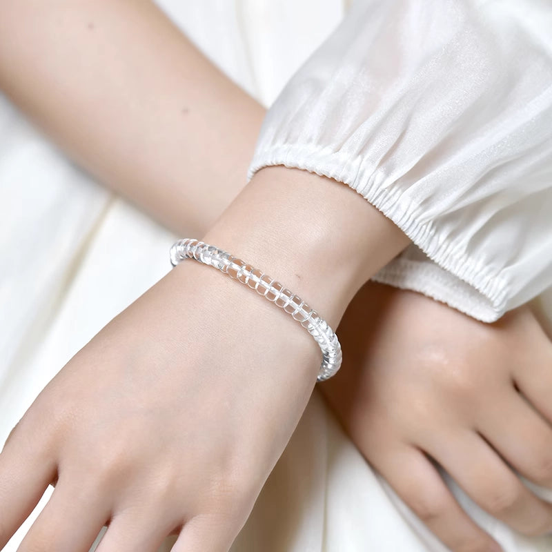Women wearing clear quartz bracelet, polished natural quartz crystal wrist jewelry for daily spiritual use