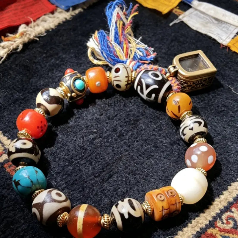 webp Close-Up of Dzi Bead and Yak Bone Beads on