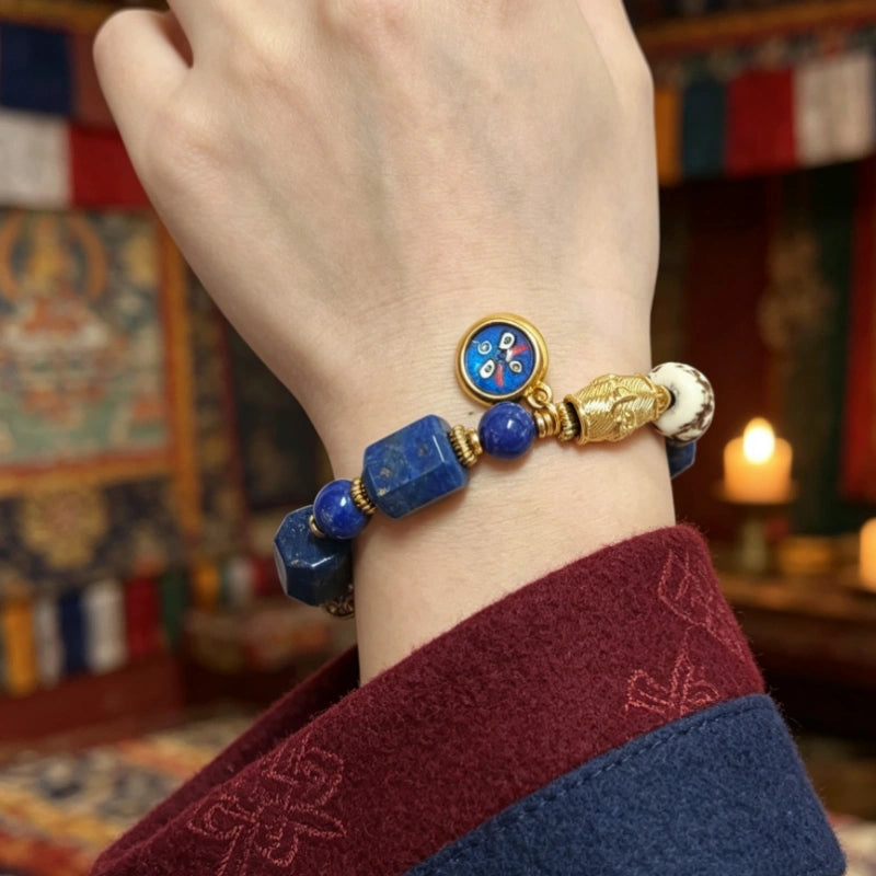 Woman wearing a lapis lazuli bracelet with a Black Jambhala wealth charm and carved yak bone skull bead
