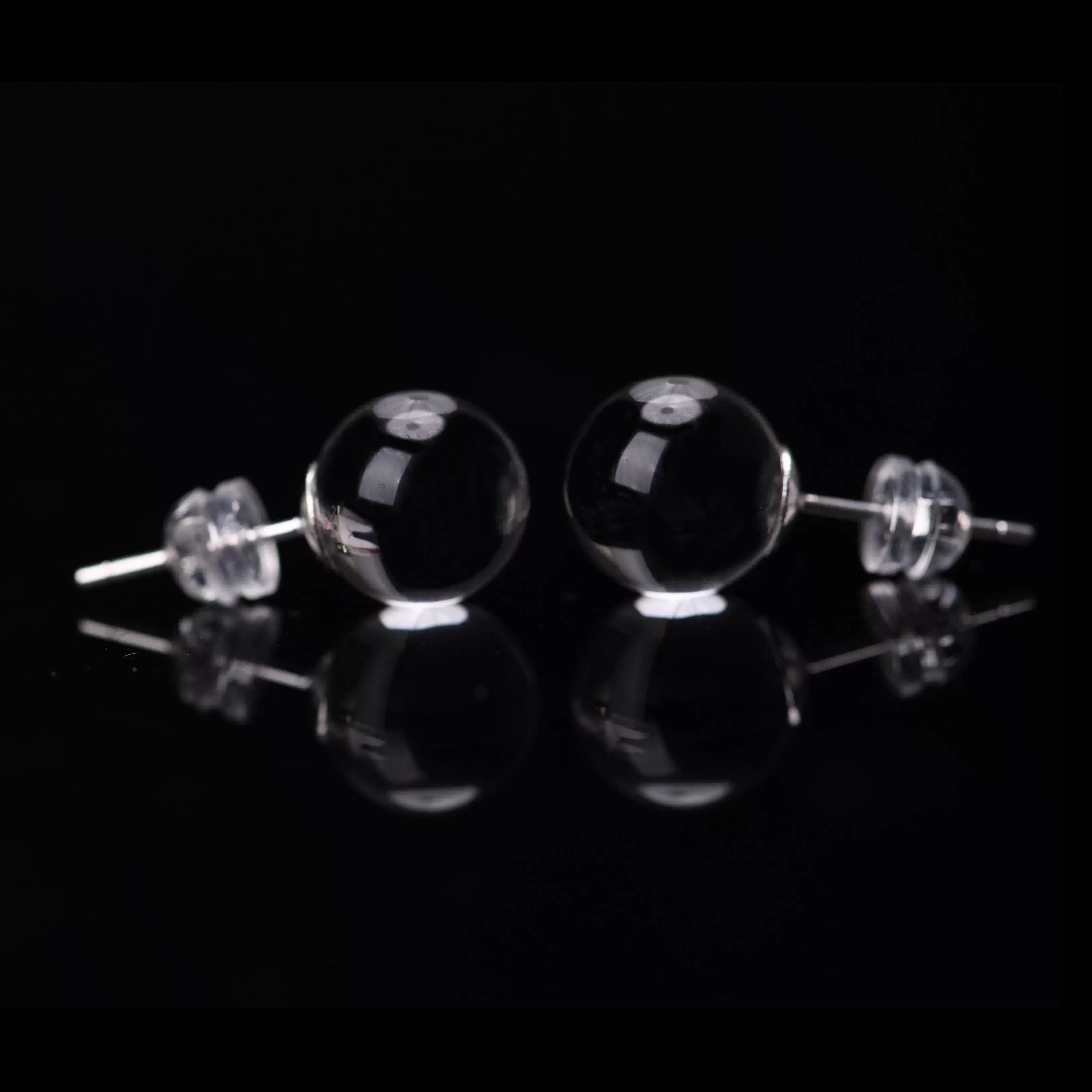 close up clear quartz gemstone drop earring detail shot