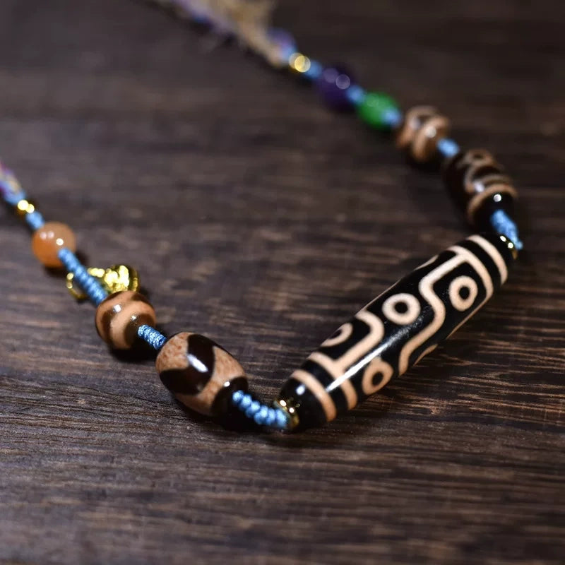  Tibetan nine-eye dzi bead necklace shown worn, in detail, and full length