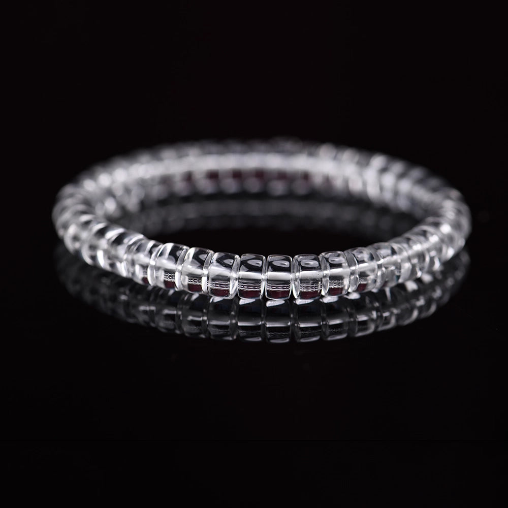 Minimalist shot of clear quartz crystal bracelet, healing energy quartz stone jewelry on black background