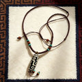 Agate Dzi Bead pendant with turquoise-tone and wooden accent beads on a braided cord