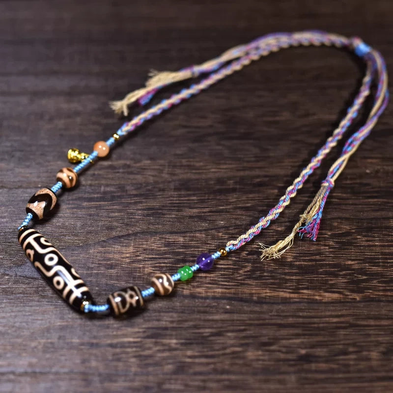 Full-length Tibetan dzi bead necklace with hand-braided cord and tassel ends
