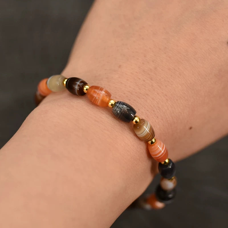 A purely handcrafted Tibetan silk agate spiritual bracelet worn on a woman's wrist, bringing inner peace and calm.