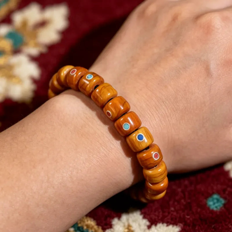 Tibetan yak bone bracelet with turquoise and red agate inlay worn on wrist