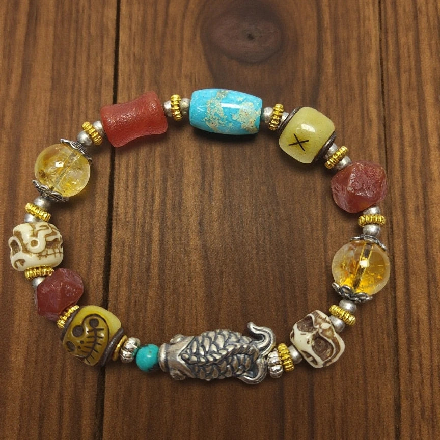 Wealth guardian fish bracelet with citrine, turquoise and Yak bone on wood background