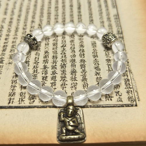 White clear quartz Tibetan Buddhist bracelet with silver guardian charm displayed