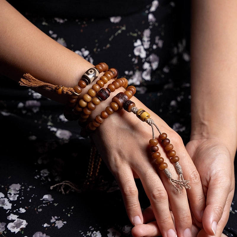 Closeup of wrist wearing handmade aged Tibetan yak bone meditation bracelet