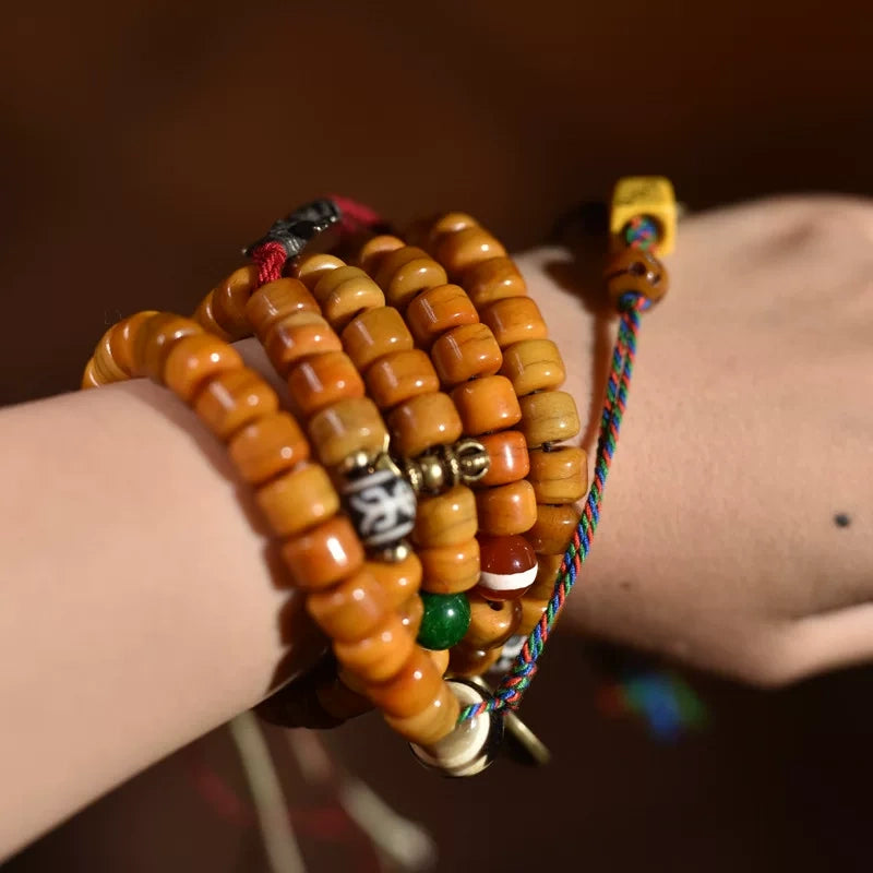 Close-up handheld view of handmade 108 yak bone mala for calm energy and inner peace